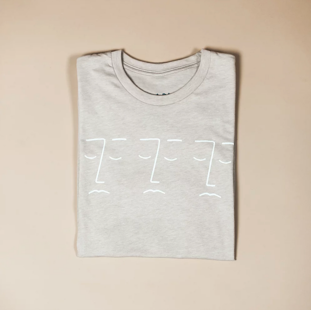 tan graphic tee with three faces design